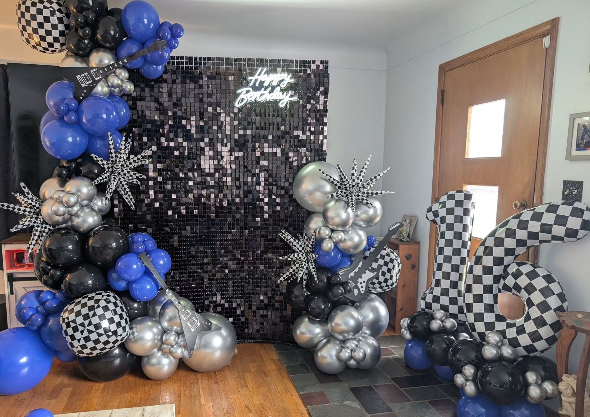 Rock and roll sweet sixteen balloon display with black sequin wall